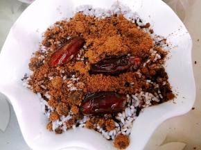 再铺上一层糯米，一层红糖粉和果干