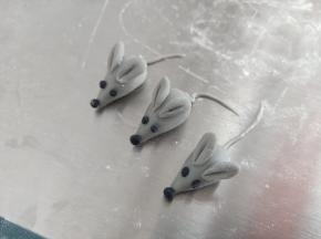 黑色面团做眼睛和鼻子，再用剩余的灰色面团搓3条尾巴，分别粘好