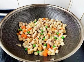 八成熟时下入杏鲍菇、胡萝卜、豌豆一起翻炒。
