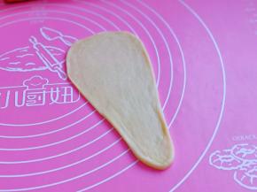 再用擀面杖擀成长舌状，上宽下窄，如图。
