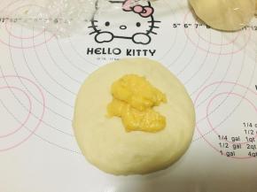 将面团擀圆，涂抹上起司酱。酱的量不易过多