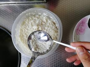 用小勺子将调好味道的米放入汤勺里，略微压平。不需要太厚。