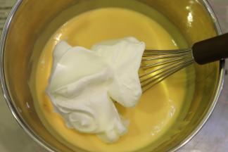 取1/3打发好的蛋白加入到蛋黄糊内，用蛋抽画半圆的手法混合好蛋糕糊。