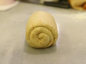 再次上下擀成牛舌状，翻面，从上往下卷好。