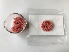 米饭煮好后，稍微放凉至不烫手时，取一张保鲜膜，在保鲜膜中间放上一团米饭，按扁。