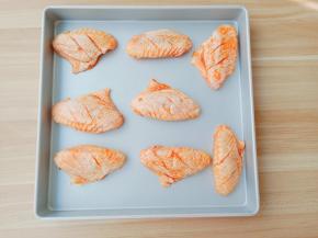 鸡翅依次码到烤盘上。