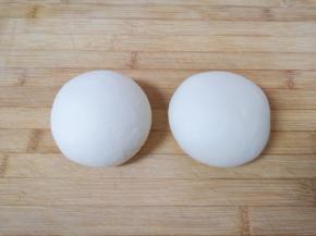 将面团分成两份，盖上保鲜膜静置20分钟。