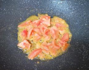 炒锅内倒适量的食用油烧热，下入西红柿翻炒至出汁。