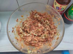 烧好的熟油倒入馅料碗内，顺着一个方向搅打上劲。