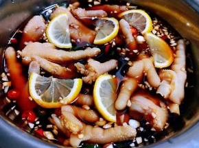 调料汁倒入容器中基本没过凤爪放入柠檬片