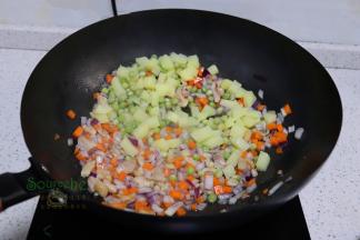 接着放土豆、胡萝卜，所有食材炒熟，加入6碗，旺火煮沸。