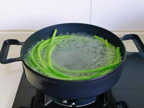 豇豆焯水: 锅中水烧开，加入2克盐，几滴食用油，放入豇豆，大火煮2-3分钟。