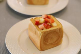 草莓洗净切小块，和放凉的吐司块一起放入大的吐司内。