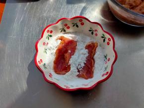 锅中倒油加热，把腌渍好的肉片沾上一层薄薄的的淀粉。