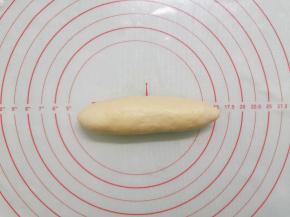 把面团反过来，从一边卷起。卷好收口朝下