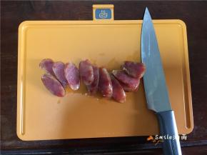 取出香肠，晾凉切成片。