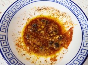 将花椒油泼在蒜末辣椒面里，搅拌均匀。