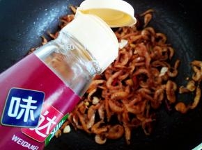 炒干后加入姜蒜辣椒等继续翻炒，烹入一点料酒去腥。