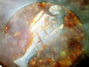 加入一勺豆瓣酱、红油辣椒或者直接用红油豆瓣也行，炒香后加入开水，把鱼放进去，煮开后转小火，盖盖焖20分钟。