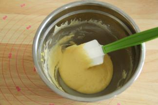 加入60克酸奶，之字形拌匀成顺滑滴落的蛋黄糊。盆边的记得刮下一起拌匀。放置一旁备用。