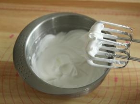 一直打到如图，提起打蛋头能拉出小尖略带点弯钩，转低速再打几圈，整理下大气泡。蛋白最后是细腻带光泽的。