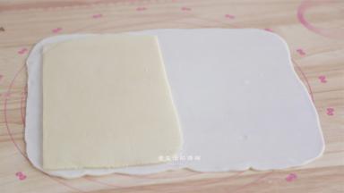 水油皮已经松弛好后，撒上少许干粉防粘，用擀面杖将其擀成长37CM，宽32CM的方块，将刚冷藏好的油酥竖着朝一边放置，盖上另一面，捏紧收口。
