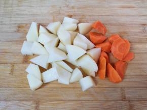 土豆和胡萝卜去皮洗干净切成滚刀块，用凉水泡上备用。