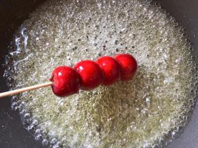 将山楂放入快速裹上一层糖浆即可，拿起会马上凝固，