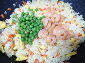 下入焯熟的豌豆和煎好的虾仁翻炒均匀。