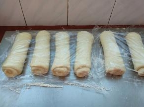 全部卷好，盖保鲜膜松弛15分钟。