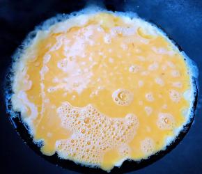 锅中倒入底油加热再倒入搅好的蛋液