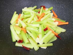 下入莴笋条，翻炒至莴笋条变软。