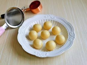 揉圆的小奶球摆盘，准备好细筛及可可粉。