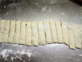 用菜刀将面卷切成1.5-2厘米宽的条。