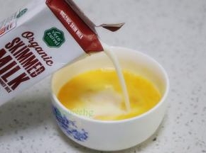 接着倒入牛奶，顺时针搅拌均匀，牛奶和鸡蛋完美结合。如果有气泡，用勺子撇掉。