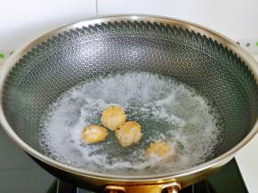 锅中加入纯净水烧开，下小鲍鱼，大火煮30秒捞出，目的是杀菌。