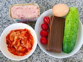 准备原材料荞麦冷面、黄瓜、鸡蛋、午餐肉、辣白菜、圣女果