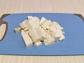 豆腐倒扣在砧板上，切小块。