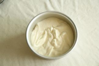 从高处倒入六寸模具中。八分满。左右晃下模具，面糊自然晃平了。然后提起模具，离桌面20公分处放手，震2下震出大气泡。