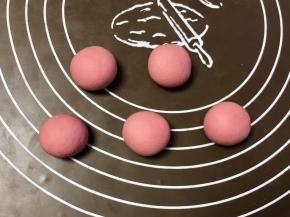 把红色面团分成12克/个的小面团，揉圆，要做几个就揉几个，剩余的面团可以做别的造型。