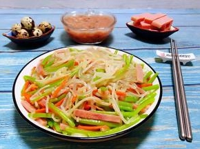 鲜嫩可口的豆芽茼蒿火腿炒粉条装入盘中就大功告成了