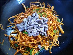 将前面炒好的肉丝倒回锅里，翻炒拌匀。