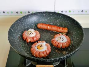 全程小火将香肠与蛋煎熟，撒上熟黑芝麻，这里估计会有人疑问，怎么只有3个花式蛋了？另外一个被儿子拿去吃了……