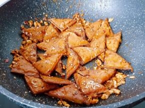 下入炸好的豆干迅速翻炒均匀。喜欢芝麻的可以撒一点。