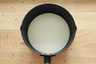 牛奶倒入不粘奶锅，细砂糖倒入牛奶中。开小火加热煮沸。要不停搅拌。