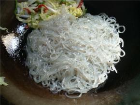 倒入粉条，翻炒均匀，可以用筷子辅助扒散。如果下锅前粉条结团了，可以再冲下水，让粉条散开，滤干水再倒入锅炒。