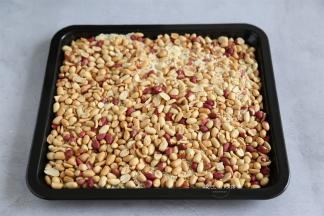 烤好的花生米取出来放至温热，用手去掉花生衣，把熟芝麻倒入花生里面，搅拌均匀，放入烤箱里，调80度保温。