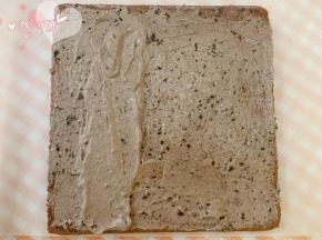 蛋糕卷的正面朝上，抹上奥利奥咸奶油。