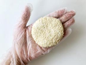 再将搓圆的糯米团放入手心，上下合拢压扁。