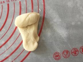 揉面垫上撒一点点干面粉，拿一块小面团像洗衣服一样来回搓